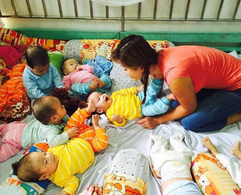Caring for babies at an orphanage.